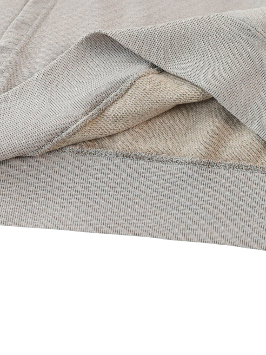 Close-up of light gray fabric with a subtle pattern on a white background