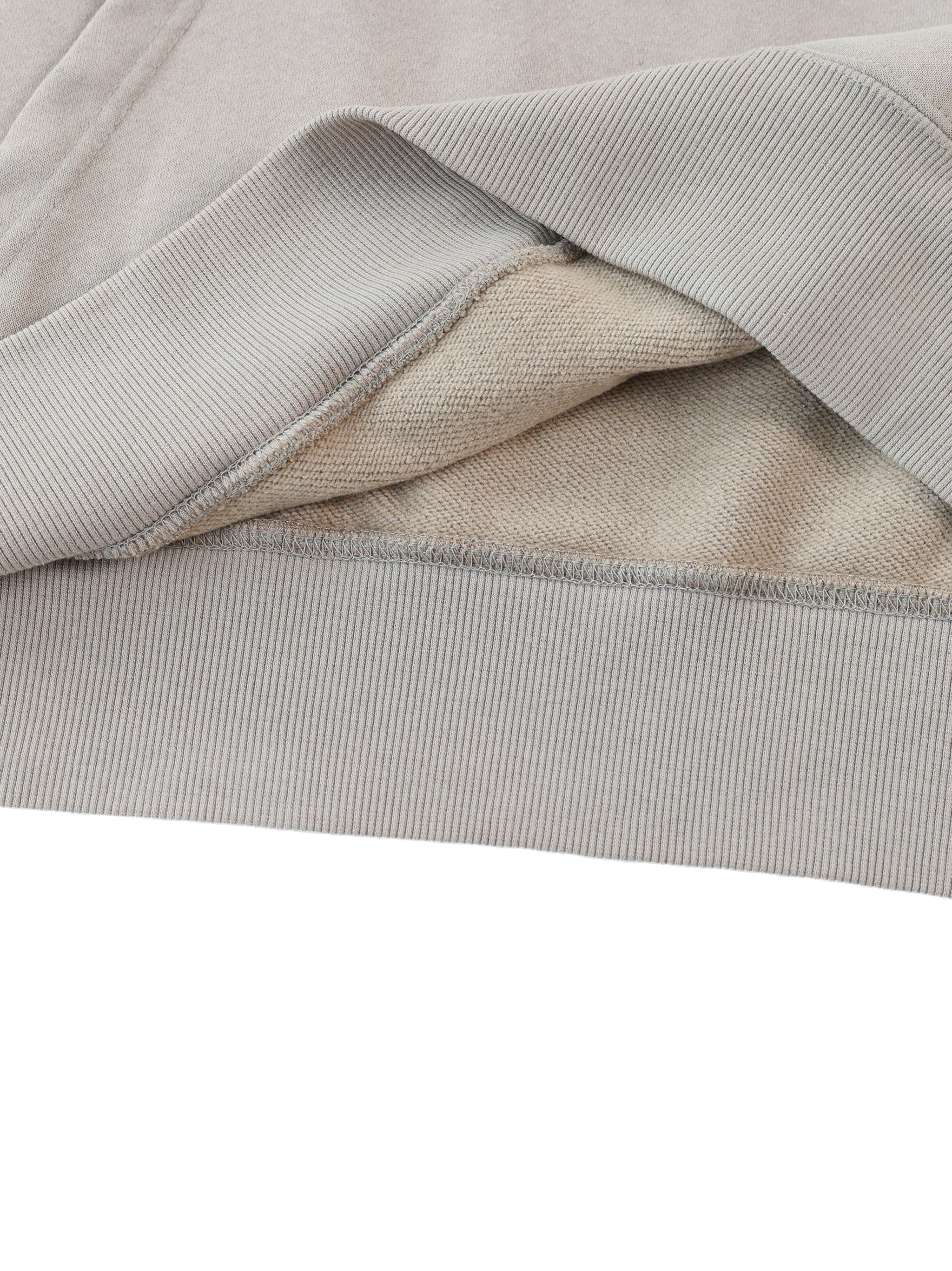 Close-up of light gray fabric with a subtle pattern on a white background
