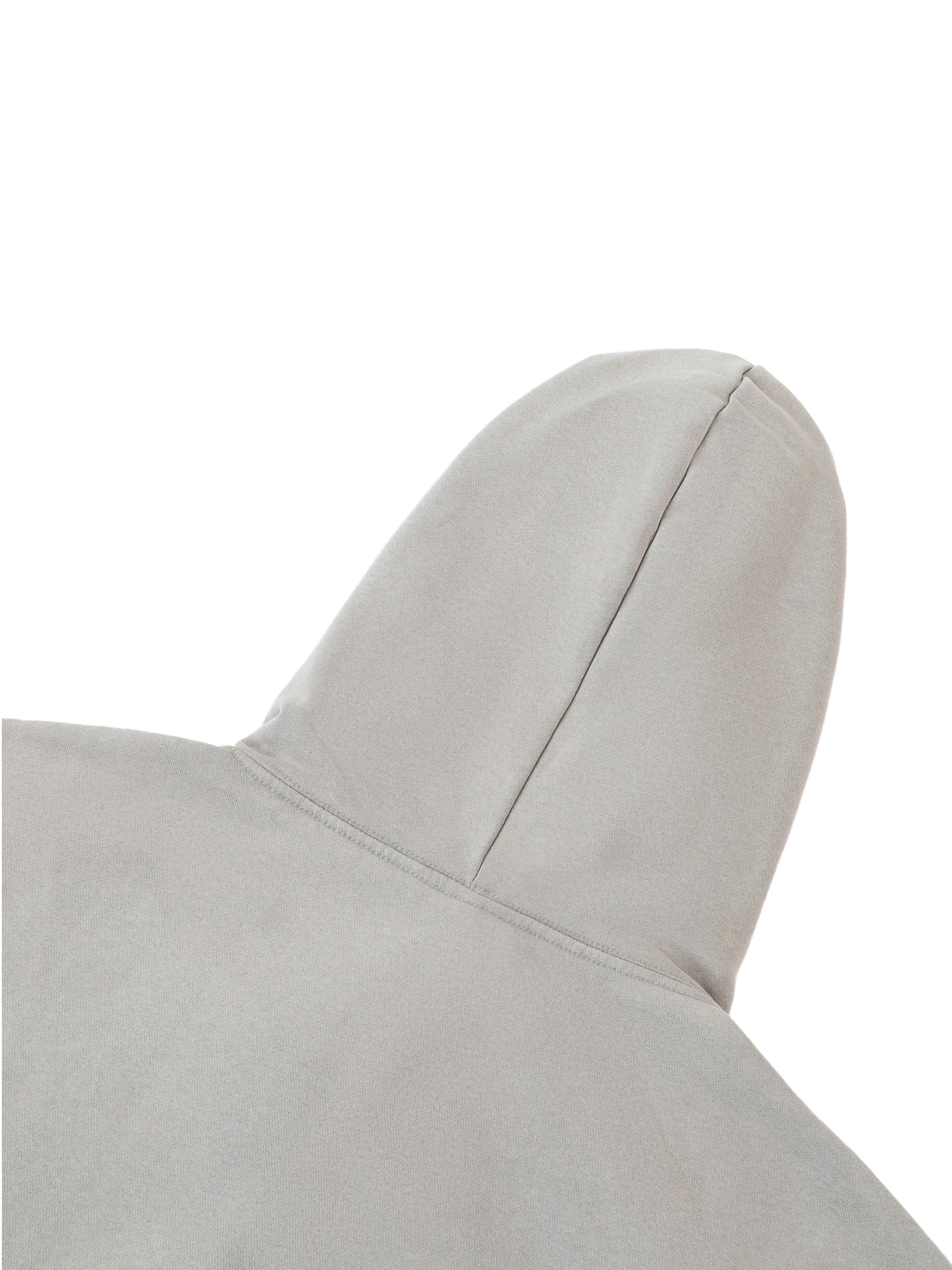 Close-up of a light gray cushion with a soft texture on a white background