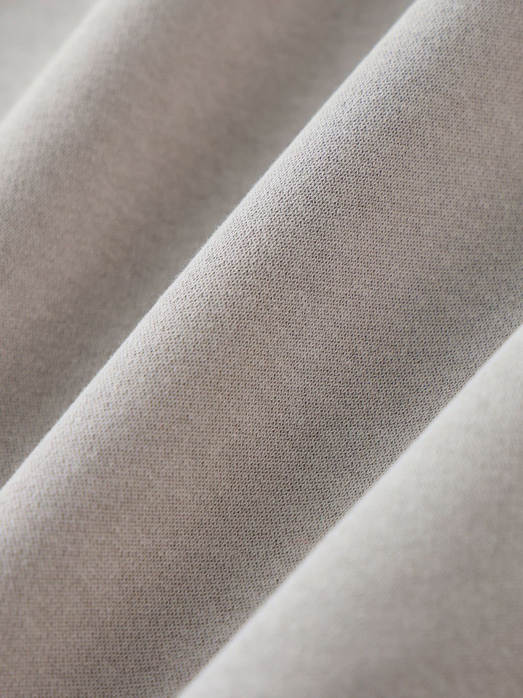 Close-up of beige fabric with a subtle pattern